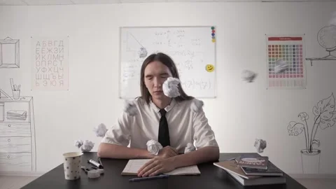 Crumpled papers fly into the face of student with long hair in slow motion Stock Footage 264511506