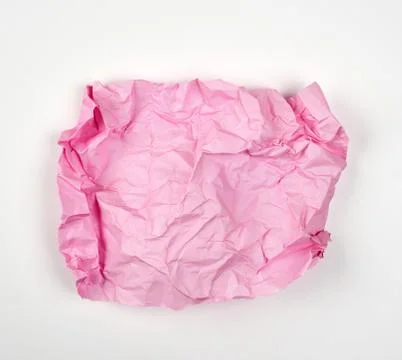 Crumpled pink rectangular sheet of paper on a white background 스톡 사진