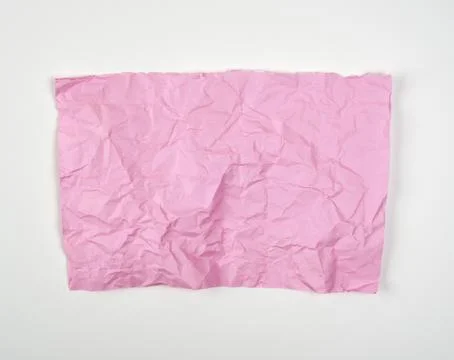 Crumpled pink rectangular sheet of paper on a white background Foto stock