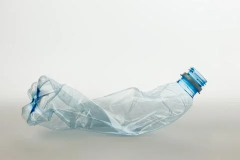 Crumpled plastic bottle. Grey isolate Stock Photos