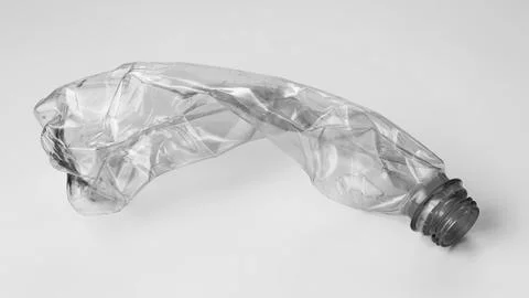 Crumpled plastic bottle on a light background. The concept of ecology Stock Photos