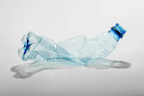 Crumpled plastic bottle on a light background. The concept of ecology Stock Photos