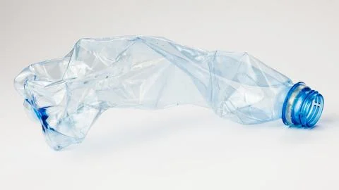 Crumpled plastic bottle on a light background. The concept of ecology Stock Photos