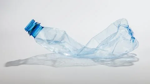 Crumpled plastic bottle on a light background Stock Photos