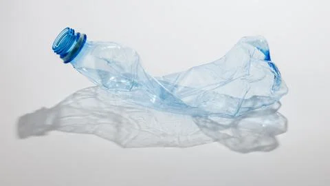 Crumpled plastic bottle on a light background. The concept of ecology Stock Photos