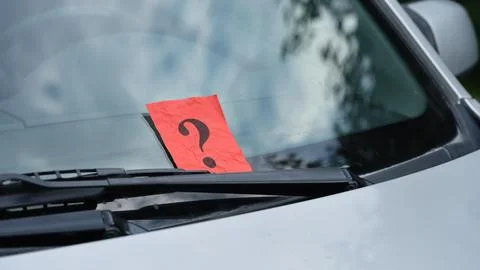 A crumpled red paper note with a black question mark 스톡 사진