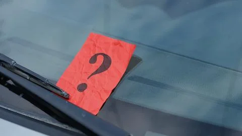 A crumpled red paper note with a black question mark 스톡 사진