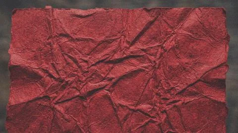 Crumpled red paper texture background closeup. Fotos Stock