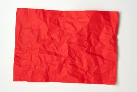 Crumpled red rectangular sheet of paper on a white background 스톡 사진