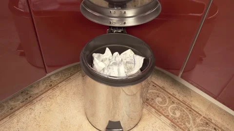Crumpled sheet of paper that turned out to be unnecessary flies into a trash can Stock Footage 297793688