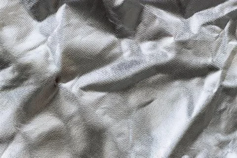Crumpled silver fabric, background. Stock Photos