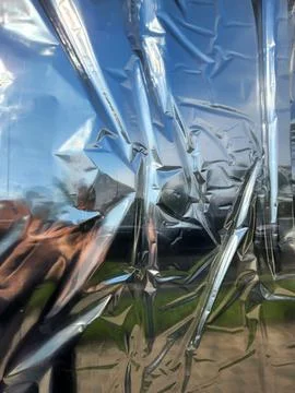 Crumpled silver foil with reflection. Silver foil background Stock Photos
