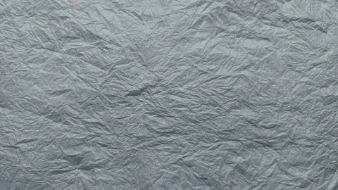 Crumpled silver foil texture background intricate wrinkles folds metallic she Stock Photos