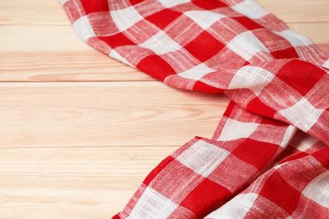 Crumpled tablecloth with checkered pattern on light wooden table, space for.. Stock Photos