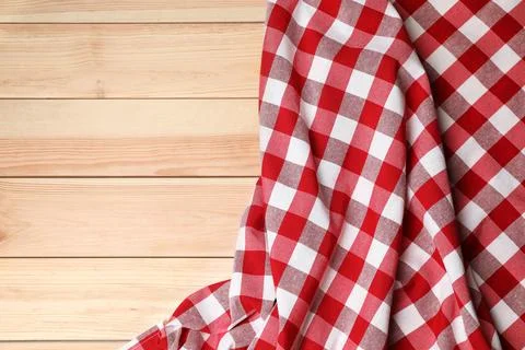 Crumpled tablecloth with checkered pattern on light wooden table, top view... Stock Photos