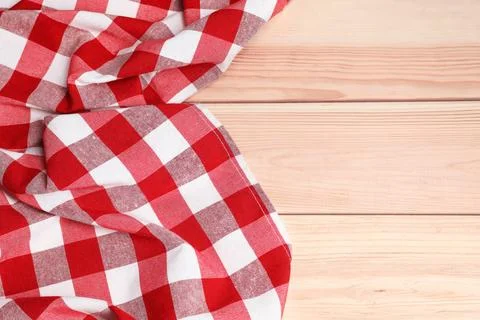 Crumpled tablecloth with checkered pattern on light wooden table, space for.. Stock Photos