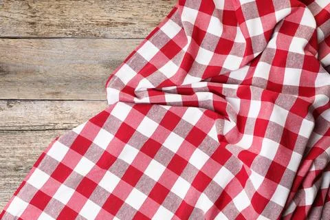 Crumpled tablecloth with checkered pattern on wooden table, top view Stock Photos