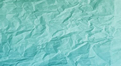 Crumpled turquoise paper texture background with creased folds . Stock Photos