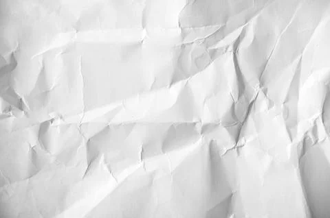 Crumpled white blank sheet as texture or background Stock Photos