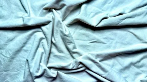 Crumpled white fabric texture flows into serene minimalist folds with soft na Stock Photos