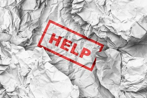 Crumpled white paper with a red rectangular stamp containing the word "HELP.. Foto stock