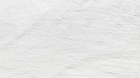 Crumpled white paper texture featuring subtle speckles and gentle creases in  스톡 사진