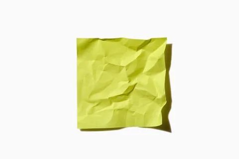 Crumpled yellow post it note on white background Stock Photos