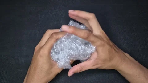 Crumpling bubble warp Stock Footage 297546546