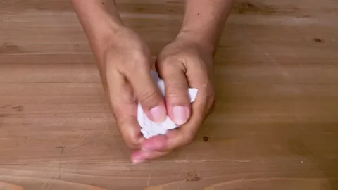Crumpling up the paper on the table Stock Footage 345587499