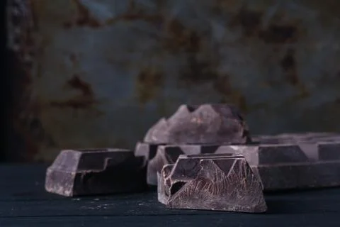 Crunch dark chocolat on rustic table Stock Photos