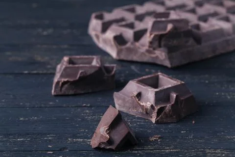 Crunch dark chocolat on rustic table Stock Photos