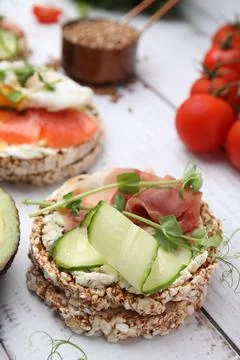 Crunchy buckwheat cakes with cream cheese, prosciutto and cucumber slice on w Stock Photos
