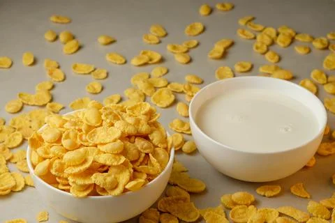 Crunchy corn flakes ready to be enjoyed with chilled milk on a sunny morning Stock Photos