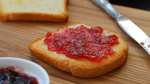 Crunchy hot toasts with jam Stock Footage