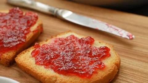 Crunchy hot toasts with jam Stock Footage 69748670