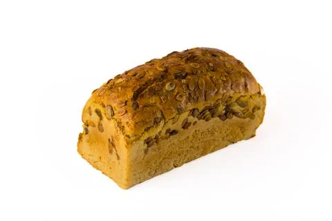 Crunchy loaf of nutritious while wheat bread with pumpkin seeds isolated on Stock Photos