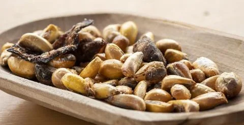 Crunchy Roasted Corn Snack on Rustic Wooden Plate Stock Photos