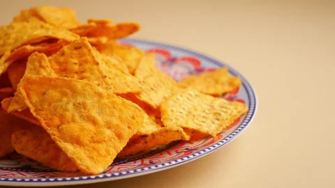 Crunchy snack on a blue patterned plate in kitchen Stock Footage 323338403