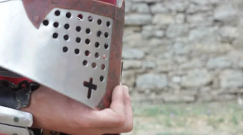 Crusader in light armor keeps the helmet in his hand Video stock 32899941