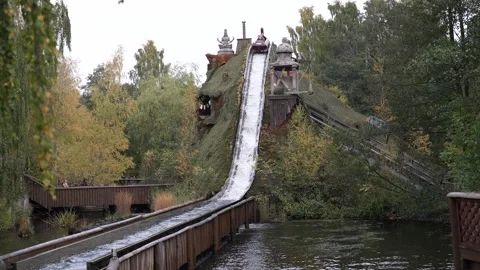 Crush down in water from water roller coaster in amusement park. Stock Footage 243761998