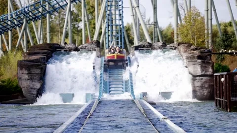 Crush down in water from water roller coaster in amusement park. Stock Footage 245455444