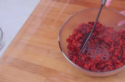 Crushed beets with crush in a container Stock Photos