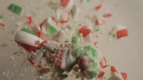 A Crushed Candy Cane Placed On A White Table Turning Counterclockwise - Stock Footage 123703778