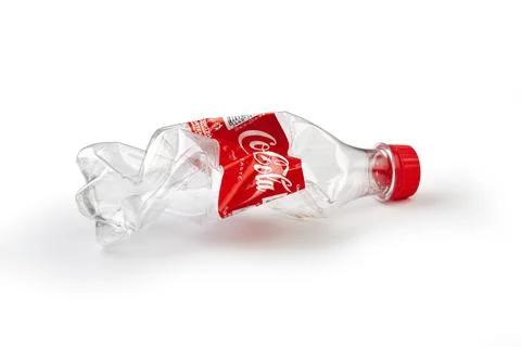 Crushed Coca-Cola plastic bottle symbolizing environmental pollution Stock Photos