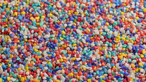 Crushed colored stones on flat surface, slowly spinning, loopable closeup Stock Footage 173071449