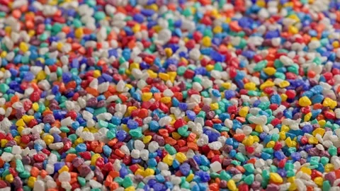 Crushed colored stones on flat surface, slowly spinning, loopable closeup Stock Footage 173377800