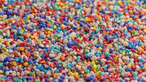 Crushed colored stones on flat surface, slowly spinning, loopable closeup Stock Footage 175724076