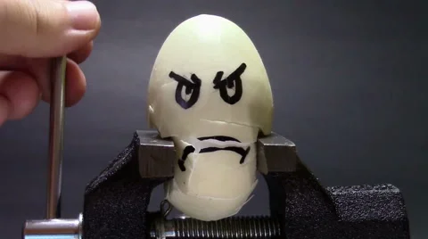 Crushed egg in the vice Stock-Footage 62771169