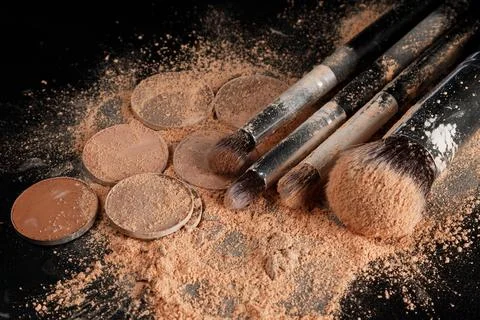 Crushed eyeshadows and make-up brushes Stock Photos
