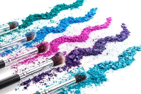 Crushed eyeshadows and make-up brushes Stock Photos